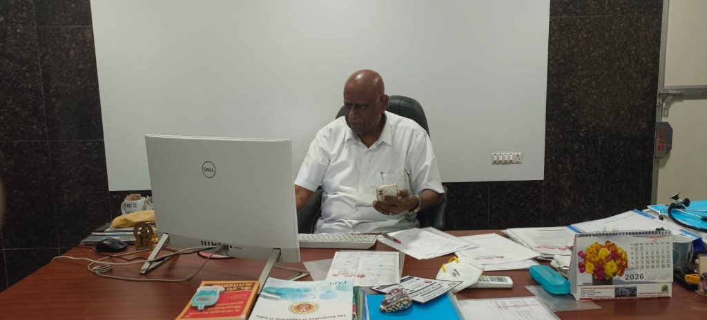 Dr. S. Arulrhaj reviewing records at desk